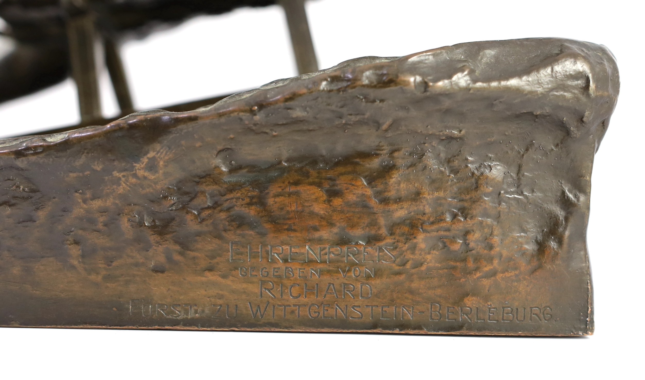 A late 19th / early 20th century German bronze model of a tobogganist, 30cm high 32cm long